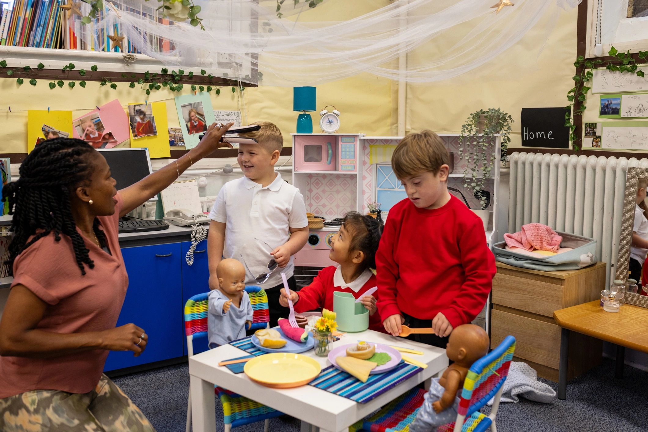 Children and educator enjoying imaginative play in an early learning classroom